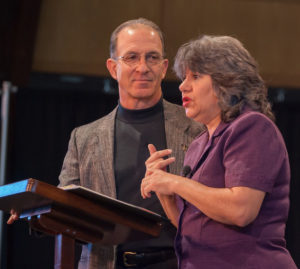 Annette & Steve Economides speaking at a convention