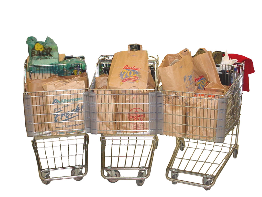 Three grocery carts full of grocery bags.