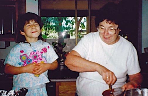 Abbey baking a cake with Nana.