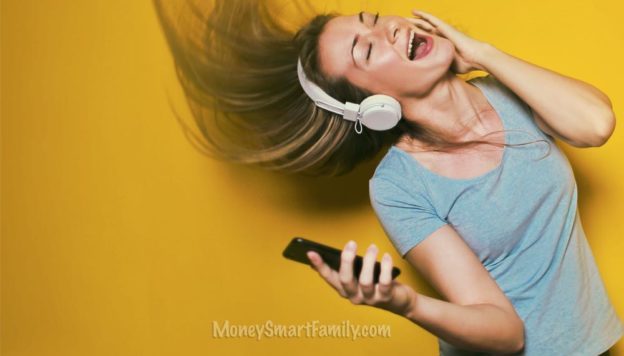 Best Free Music Apps - Woman singing while holding a cell phone