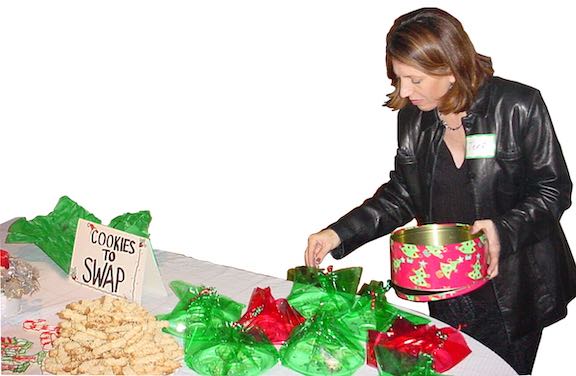 Great Holiday Entertaining on a Budget—Food, Fun, and More Festive! 3 A woman walking around a table filled with holiday cookies