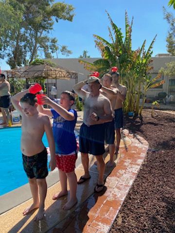 
Fourth of July pool Olympics. Fireman's relay game by the pool