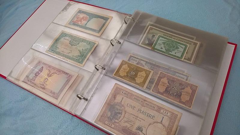A binder with a collection of foreign currency gathered on vacations.