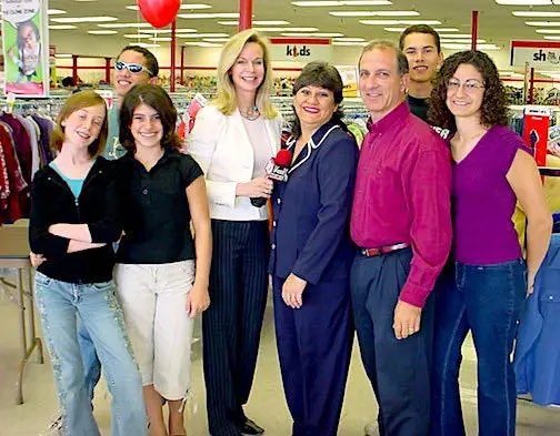 Fox10 News reporter Diane Ryan stands with the Economides Family at Savers in Phoenix, AZ.