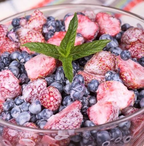 Fresh Berrys with yogurt and a mint leaf - a great snack for kids
