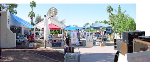 Large rummage sale on a drive way.