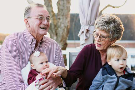 Two grandparents babysitting their grandkids.