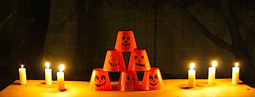 Candles and Halloween cups for a DIY squirt gun game.