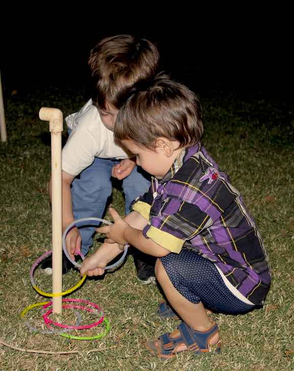 Cousins Jason and Stark play the ring game with glow stick loops.