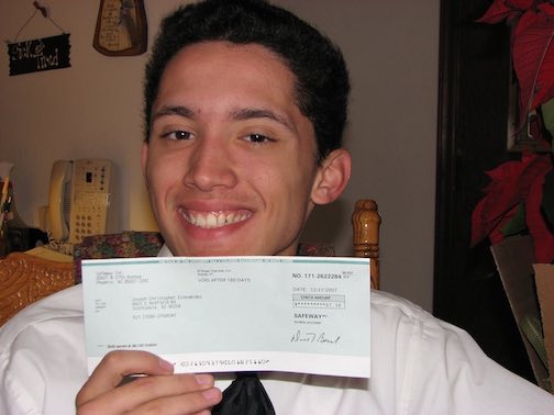 Joe's first paycheck from a job as a courtesy clerk at a grocery store.