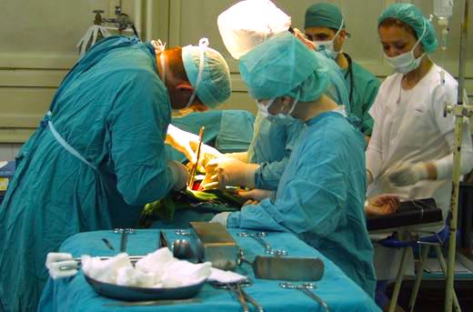 Emergency medical surgery operating room with doctor and nurses.