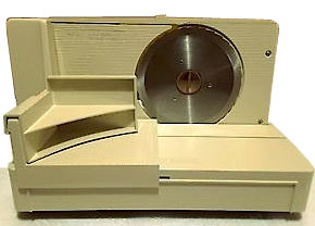 A beige Oster home meat slicer.