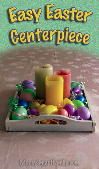 A white tray full of colored pillar candles, surrounded by colorful easter eggs and green Easter grass.