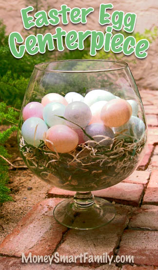 An Easter Centerpiece made with a Brandy Snifter, plastic eggs and Easter Grass, Spanish Moss or something similar.Clear Glass brandy snifter filled with Easter grass and speckled plastic Easter eggs.