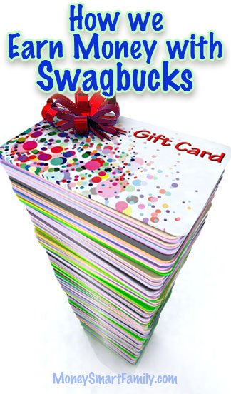 Large pile of gift cards with a red bow on top.