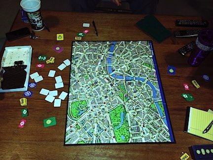 Scotland Yard board game on a wooden table.