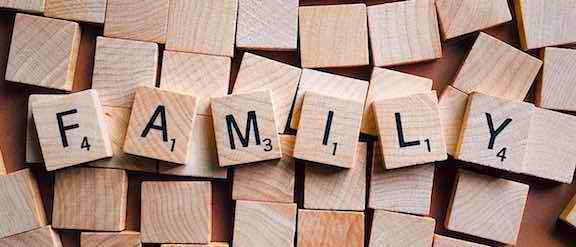 Scrabble game tiles spelling out family.