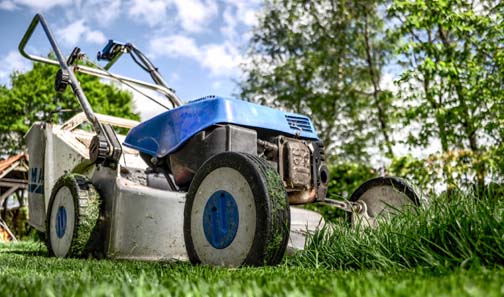 Lawn mower on green grass - a great summer job for teens.