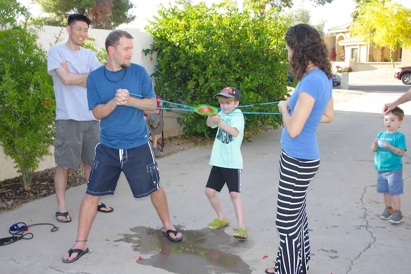 Sam using a water balloon launcher on Easter.