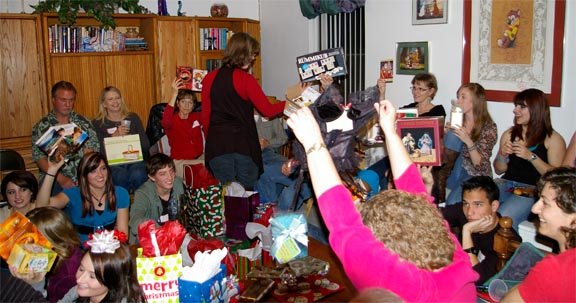White Elephant Gift Exchange presents being held up in the air.