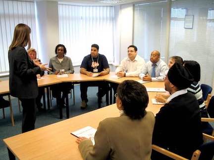 Job training room with people sitting around a table.